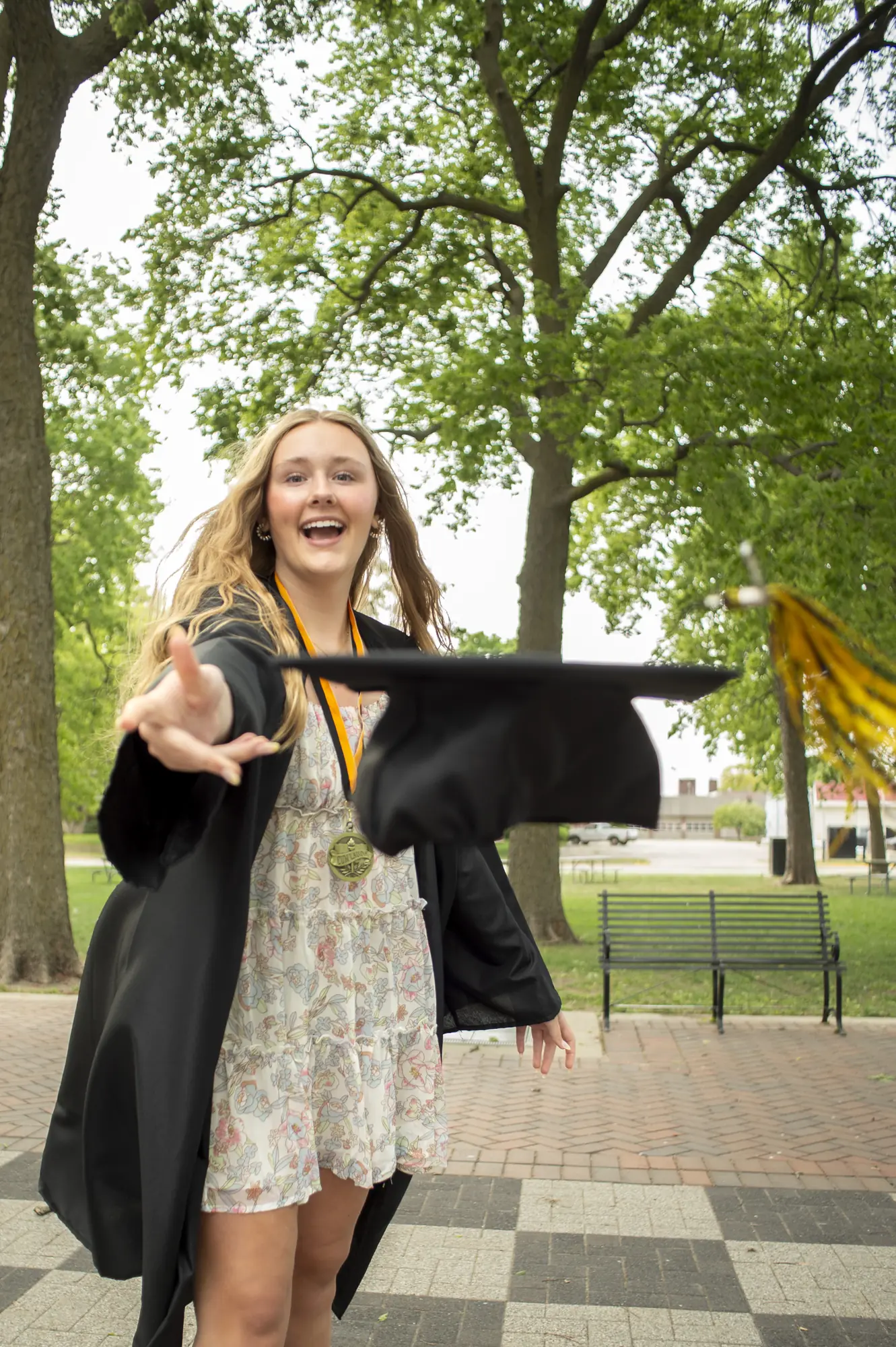 Cap and gown photos in the Cedar Valley, graduate tossing her cap