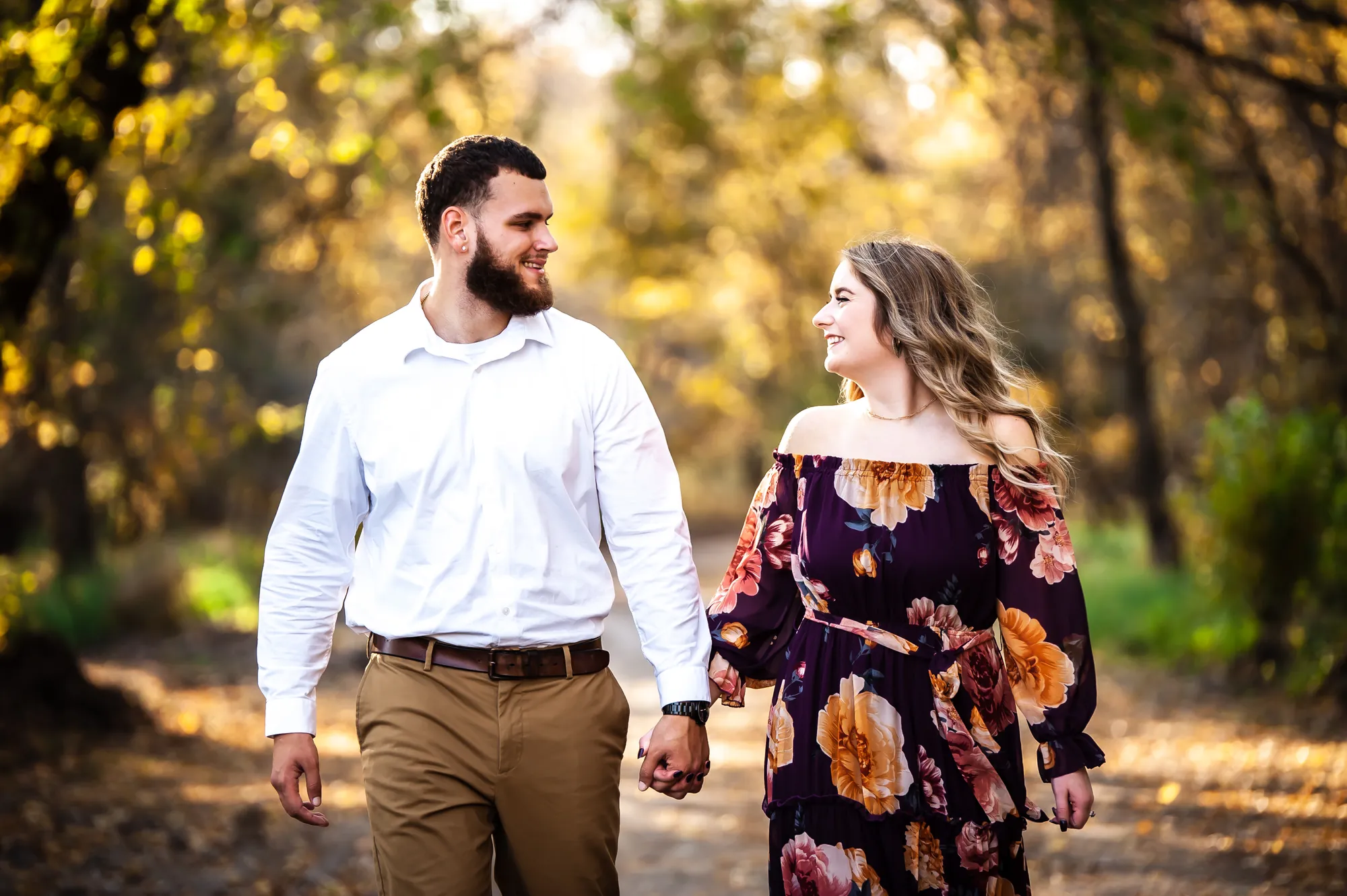 Engagement photos in the Cedar Valley, couple walking a golden fall trail