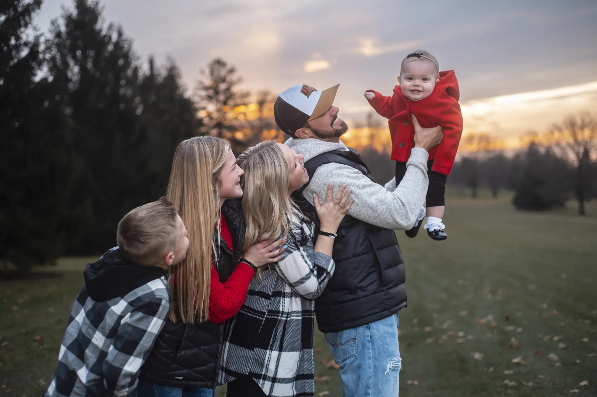 Family photos in the Cedar Valley, dad lifting the baby at sunset