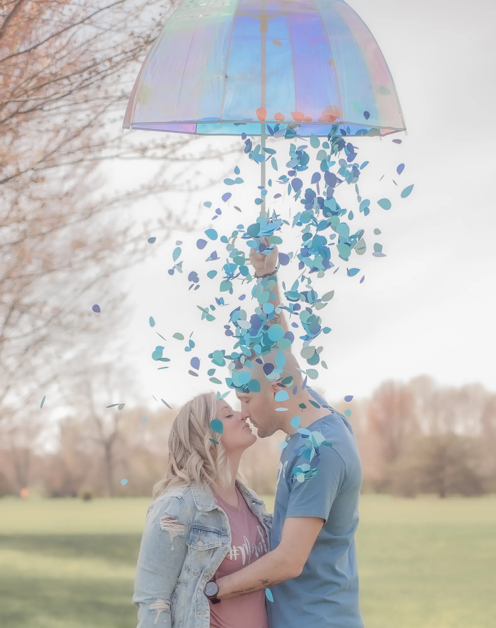 Gender reveal photos in the Cedar Valley, blue confetti falling from an umbrella
