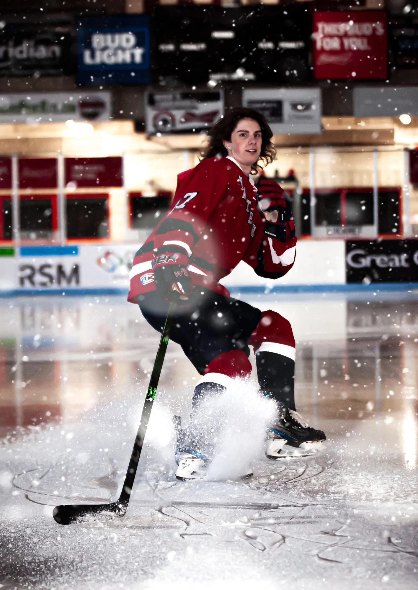 Sports photos in the Cedar Valley, hockey player skating through ice spray