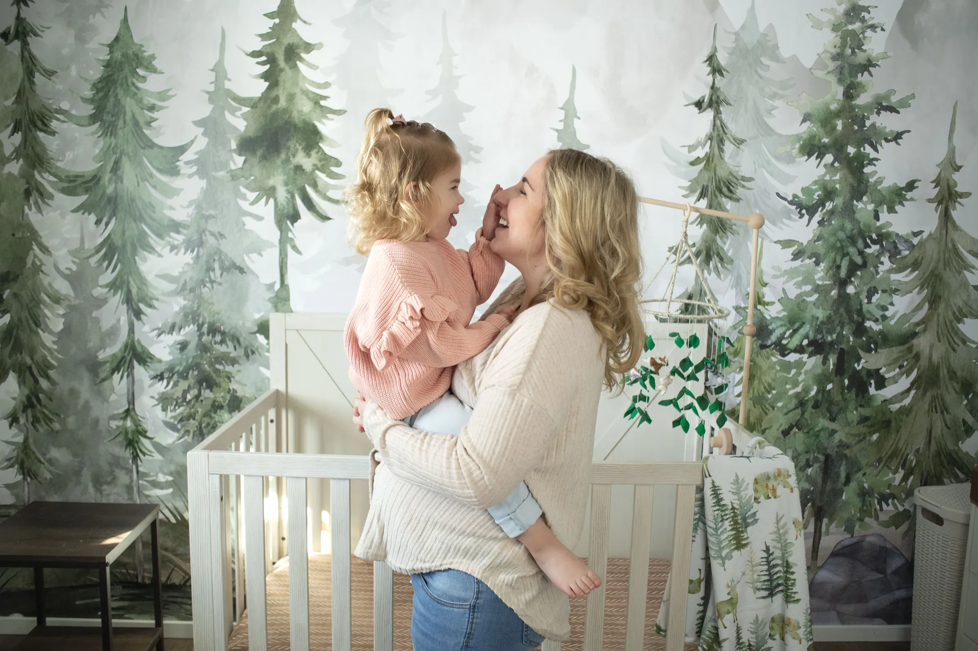 In-home family photos, mom and toddler laughing in the nursery