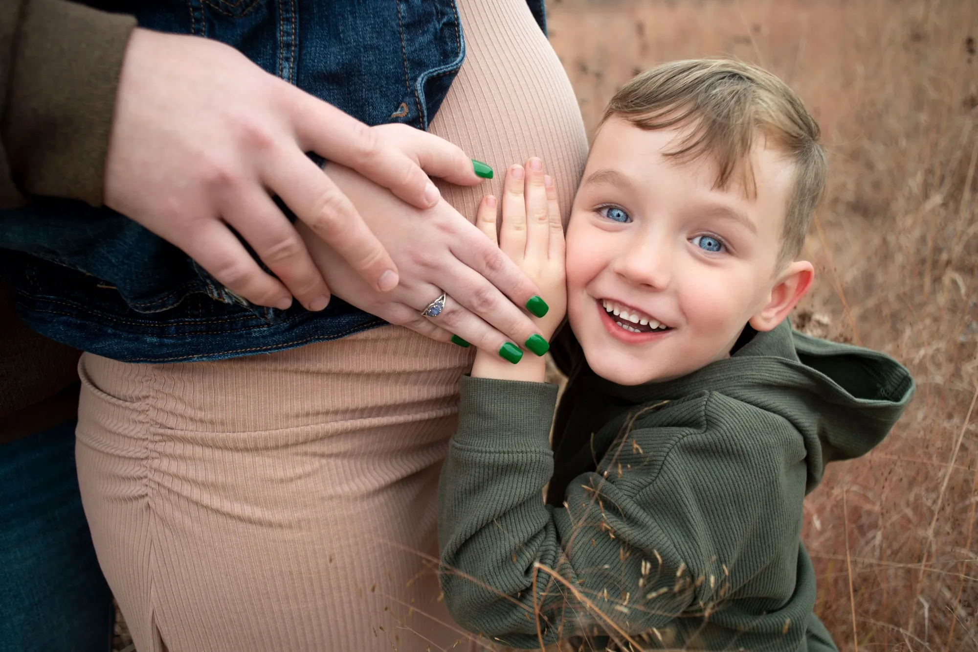 Maternity photos in the Cedar Valley, big brother hugging the bump