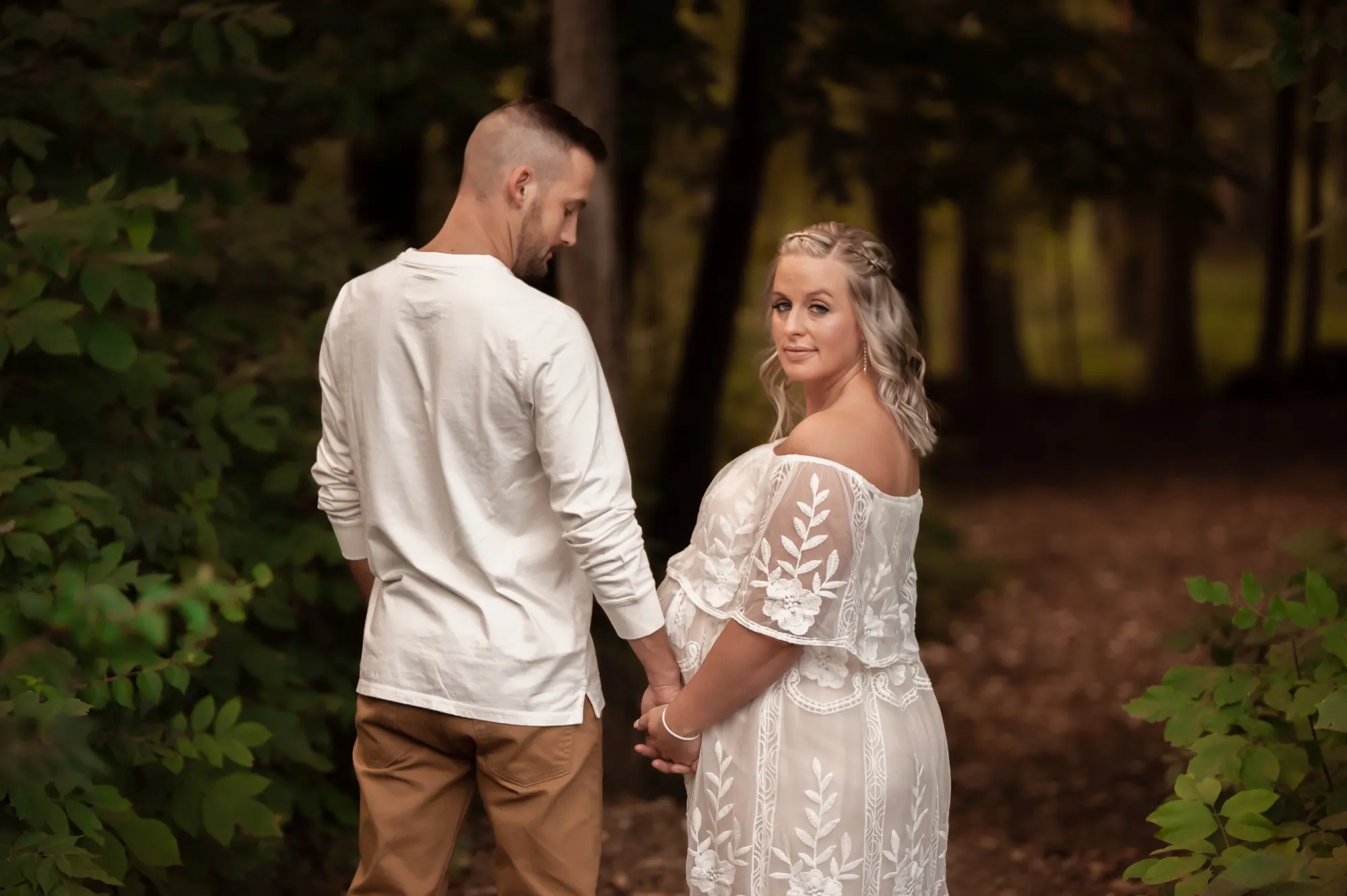 Maternity photos in the Cedar Valley, white lace dress on a wooded trail