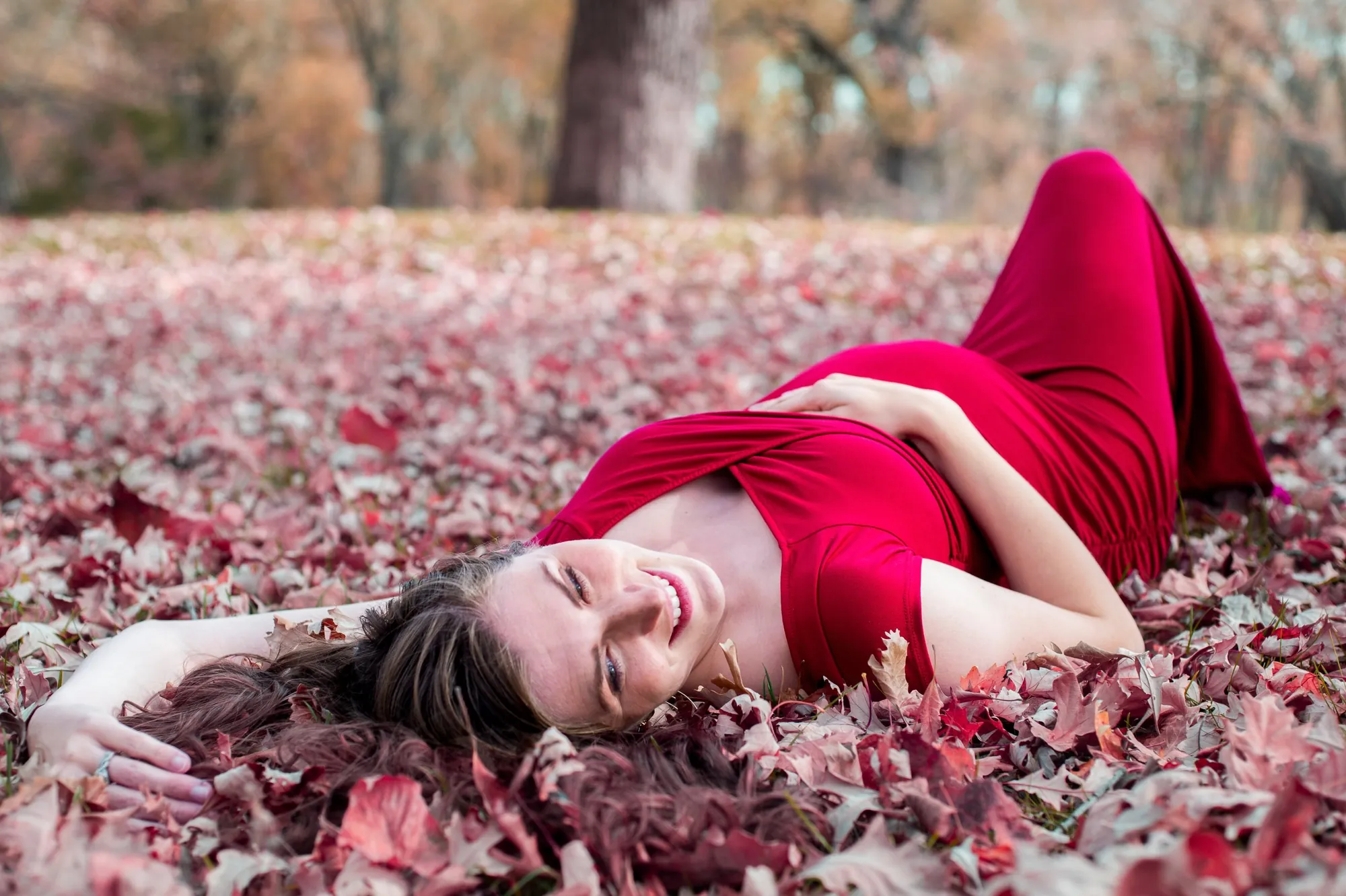 Maternity photos in the Cedar Valley, red dress in fall leaves