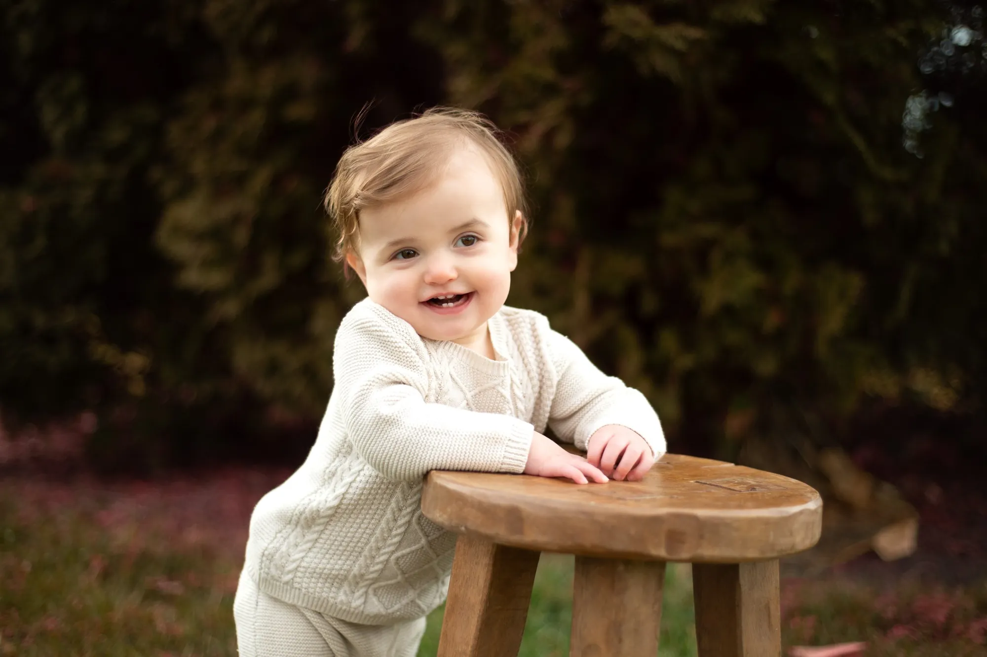 Milestone photos in the Cedar Valley, baby standing at a wooden stool