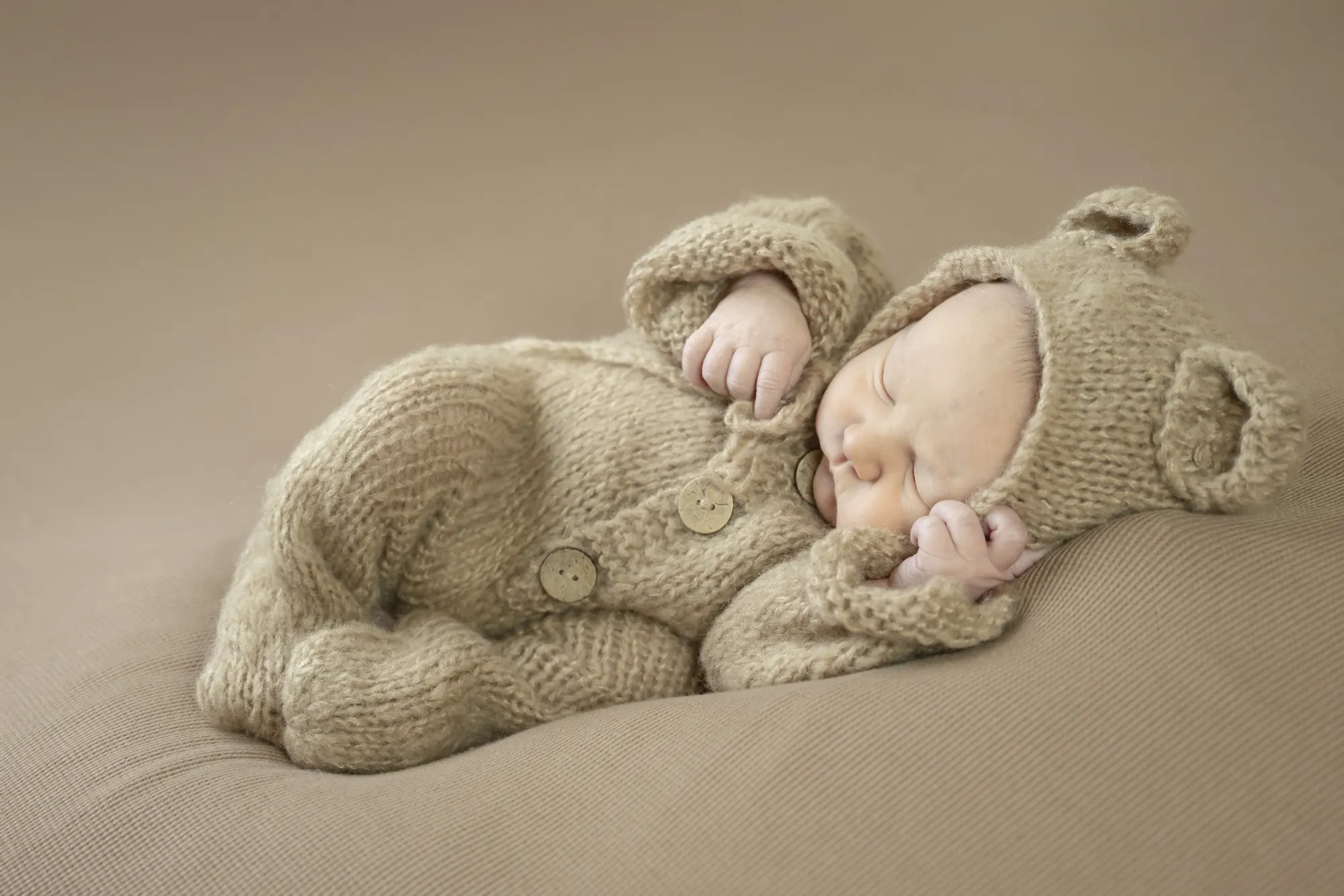 Newborn photos in the Cedar Valley, sleeping baby in a knit bear outfit