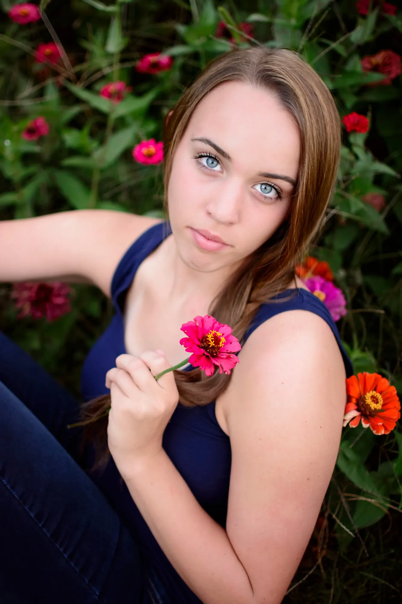 Summer senior pictures in Waterloo, Iowa with flowers.