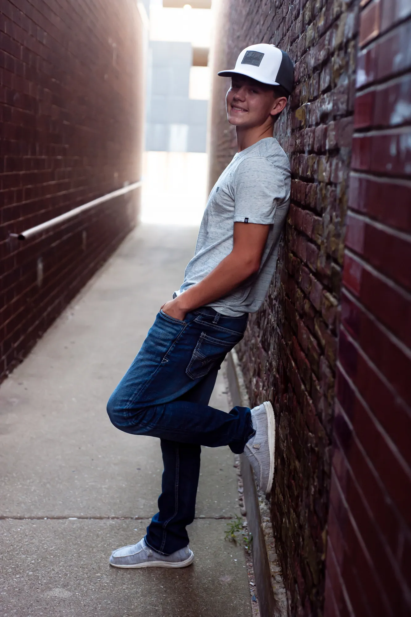 Senior pictures in the Cedar Valley, senior guy in a brick alley