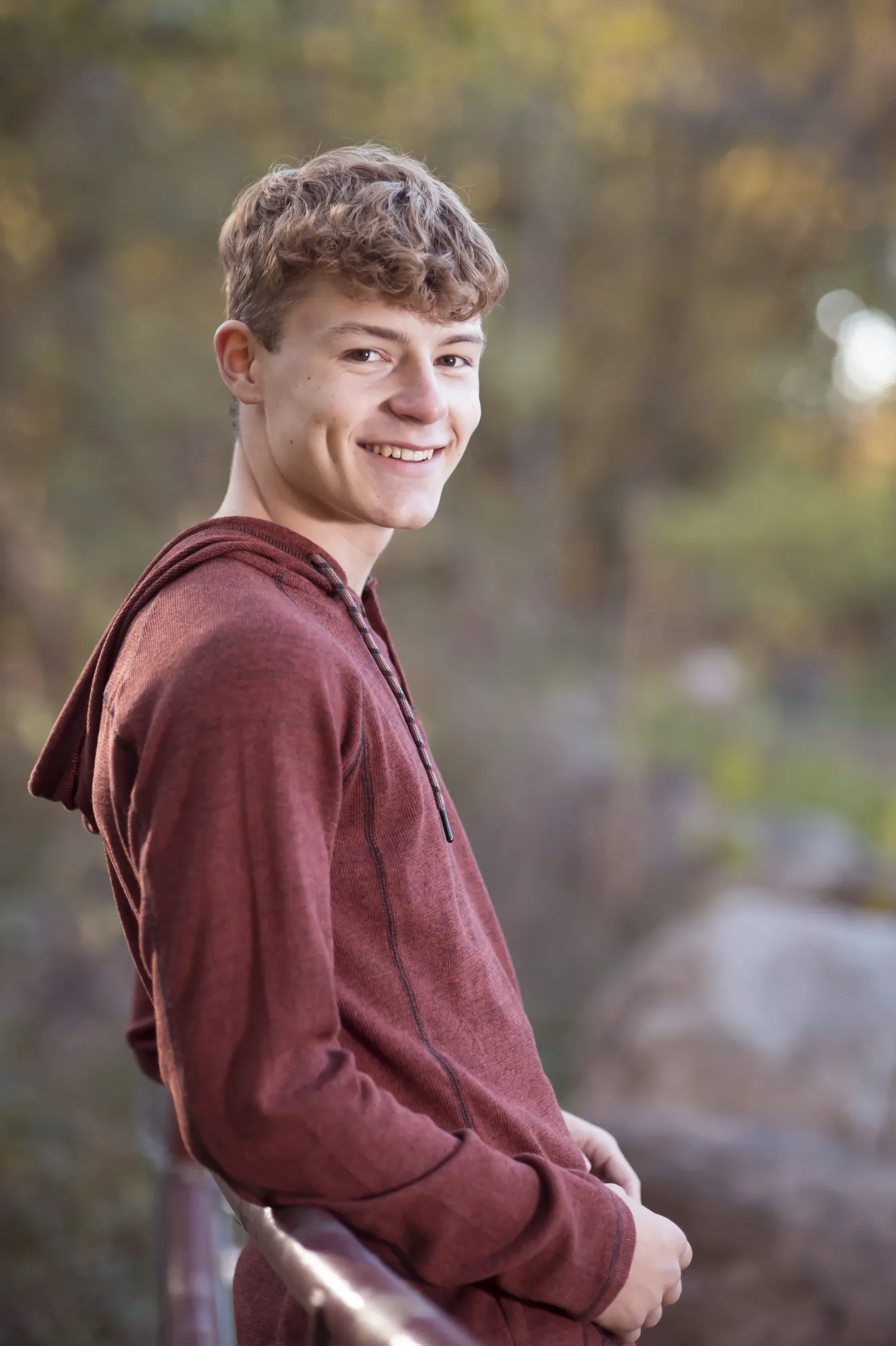 Fall senior pictures in the Cedar Valley, senior guy smiling in the woods