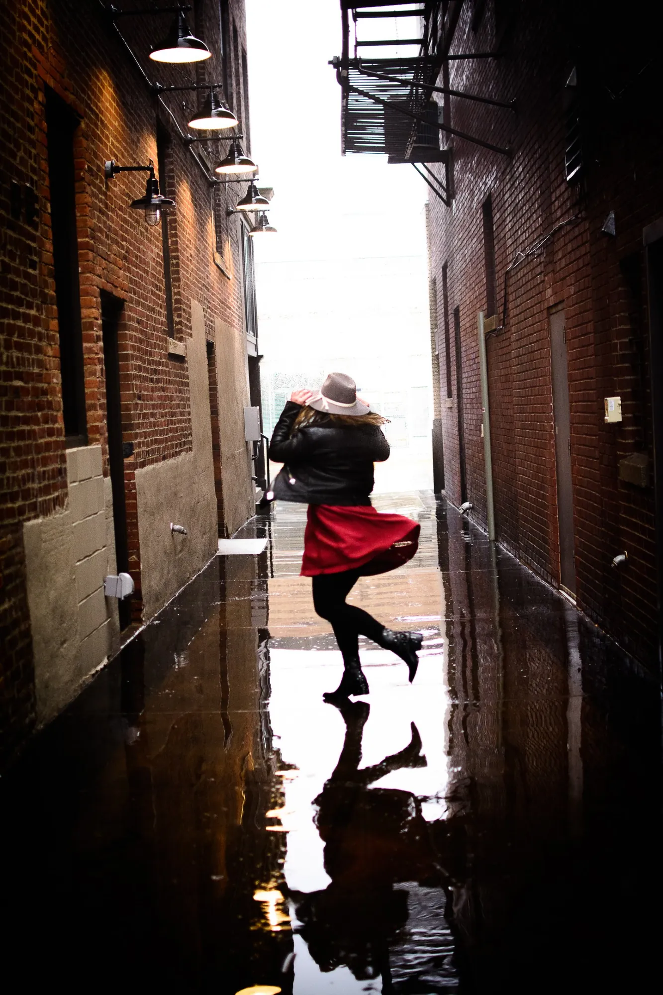 Senior pictures in the Cedar Valley, a twirl in a rainy downtown alley