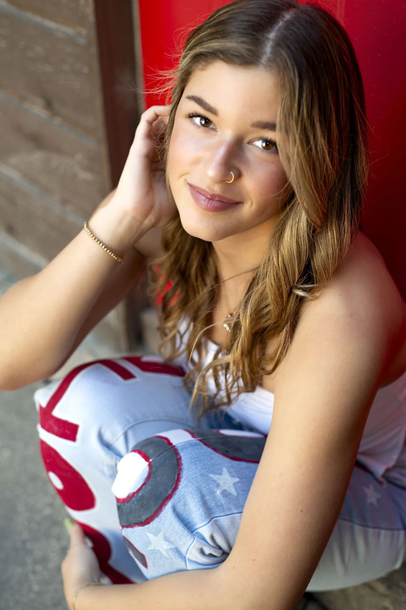 Senior pictures in the Cedar Valley, close-up portrait against a red door