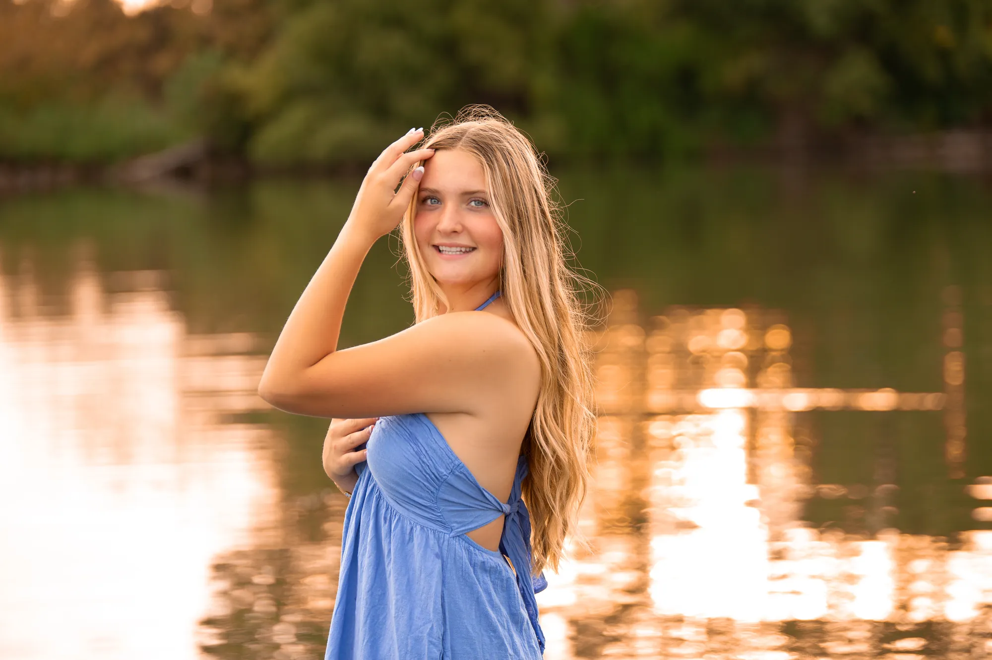Senior pictures in the Cedar Valley, blue dress by the river at golden hour