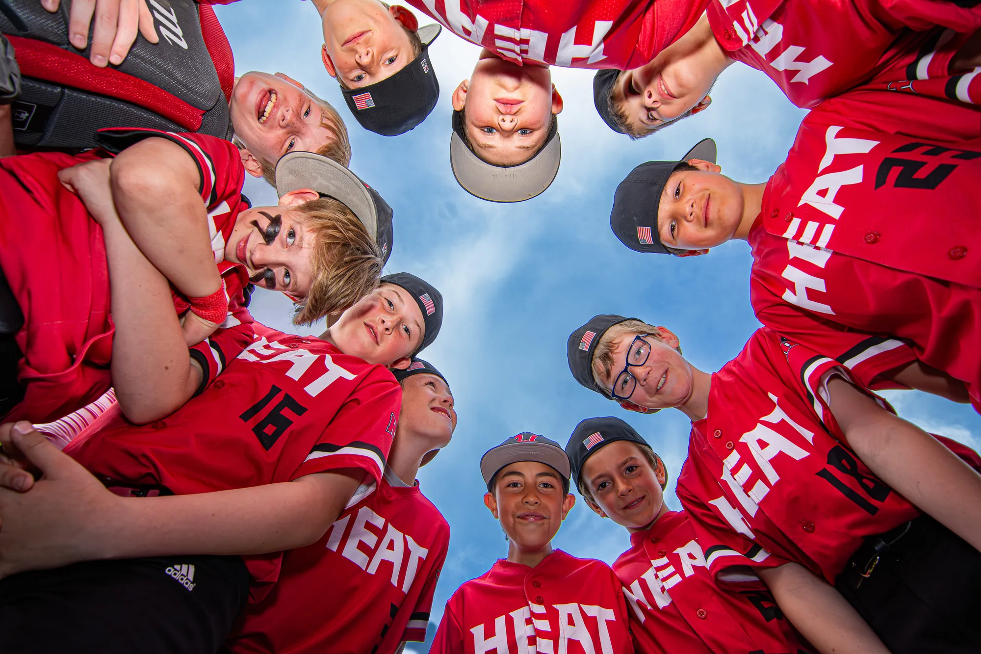Team photos in the Cedar Valley, youth baseball team huddle