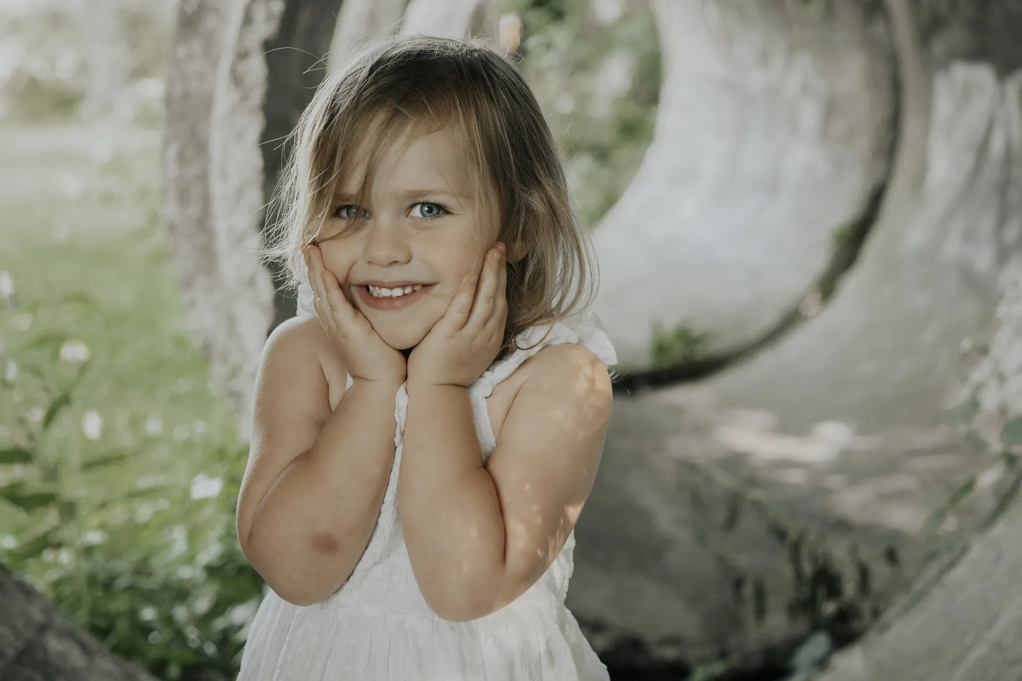 Toddler portrait in the Cedar Valley, little girl with hands on her cheeks