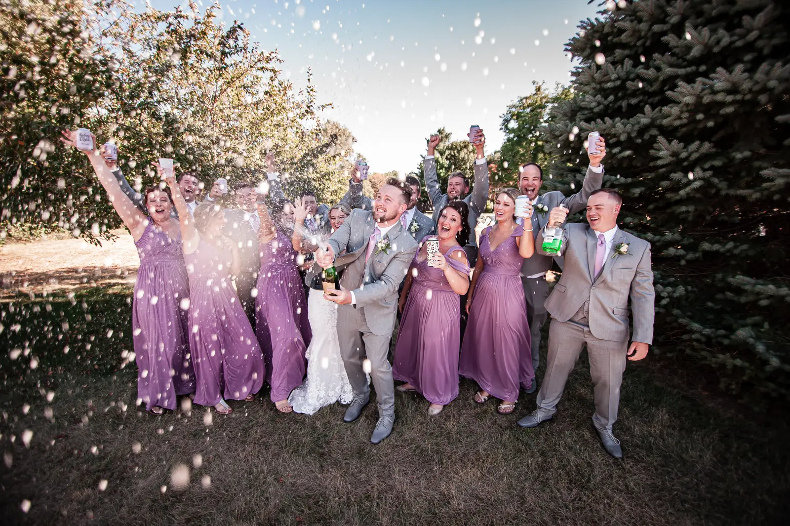 Wedding photography in the Cedar Valley, wedding party celebrating with a champagne spray
