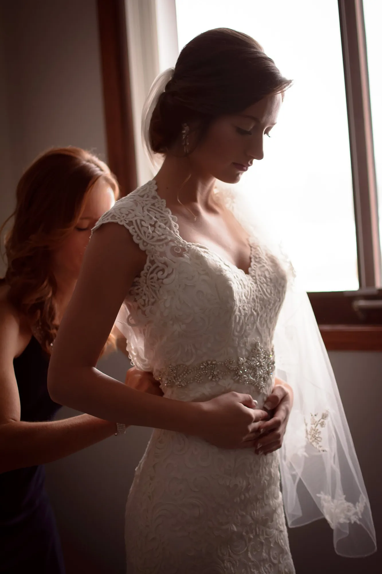 Wedding day photos in the Cedar Valley, bride getting ready by window light