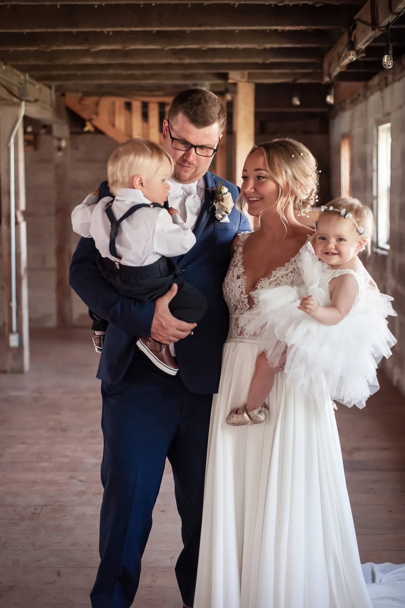 Wedding photography in the Cedar Valley, bride and groom holding their little ones