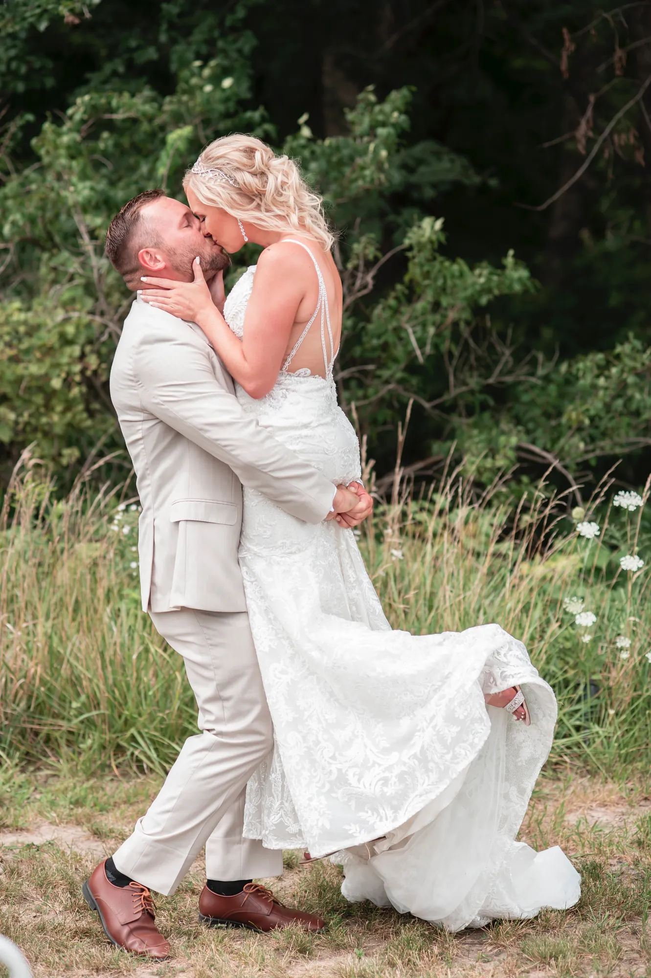 Wedding photography in the Cedar Valley, groom lifting the bride for a kiss