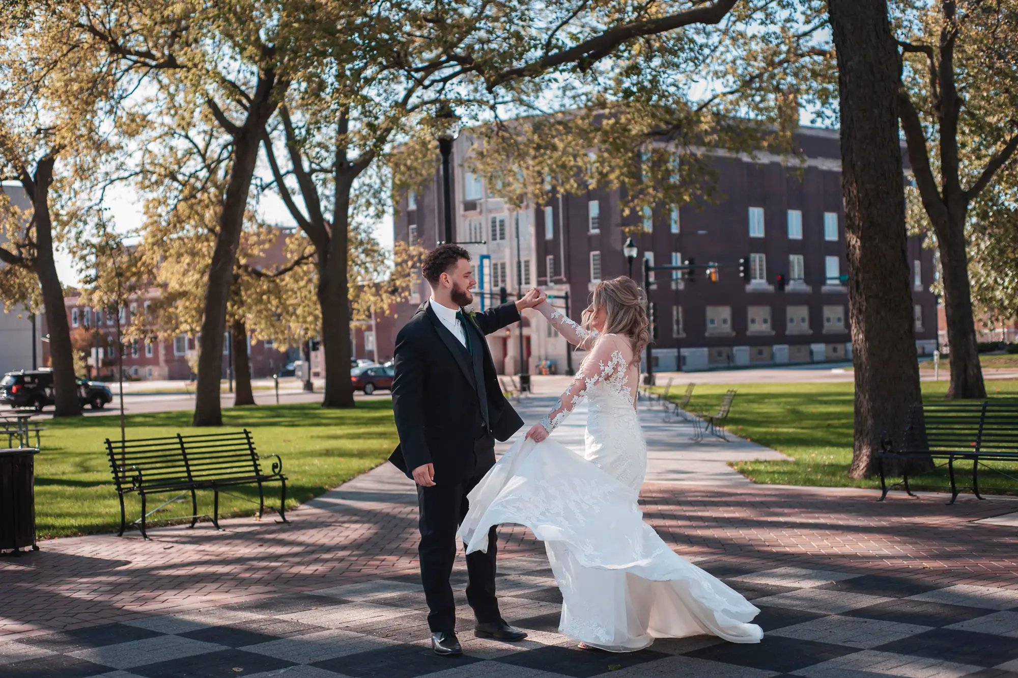 Wedding photography in Waterloo, groom twirling the bride in the park