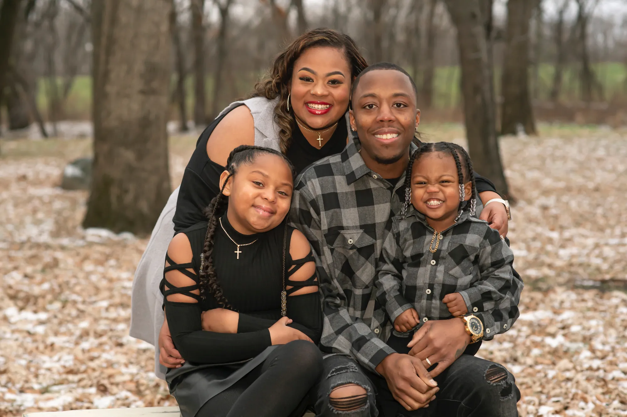 Winter family photos in the Cedar Valley, family of four smiling in the park